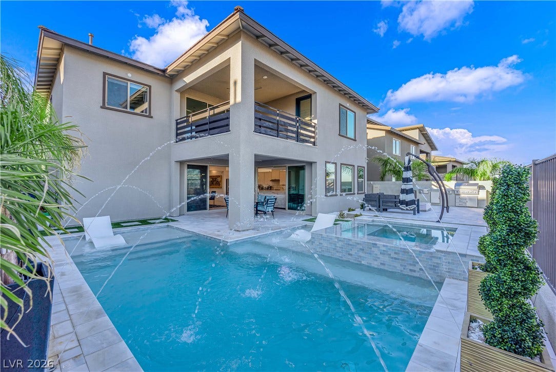 12415 Aster Hills Avenue, Las Vegas, NV 89138 backyard oasis showcases a sparkling pool paired with a modern two-story home.