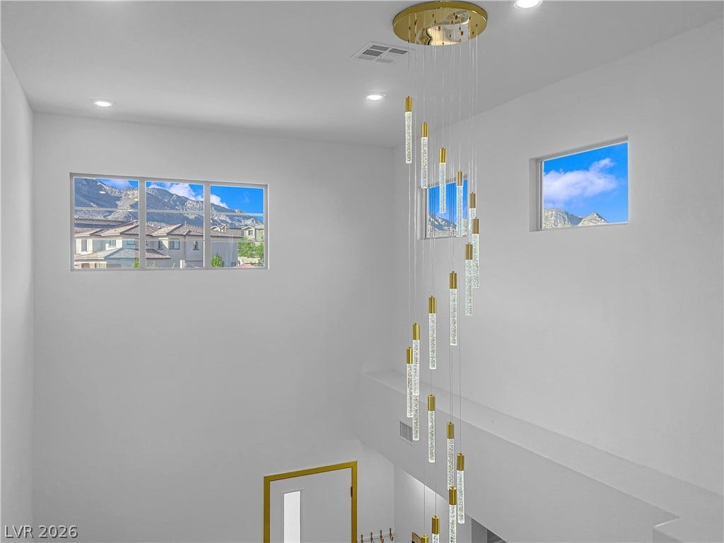 12415 Aster Hills Avenue, Las Vegas, NV 89138 Towering ceilings and elevated windows frame scenic mountain peaks.