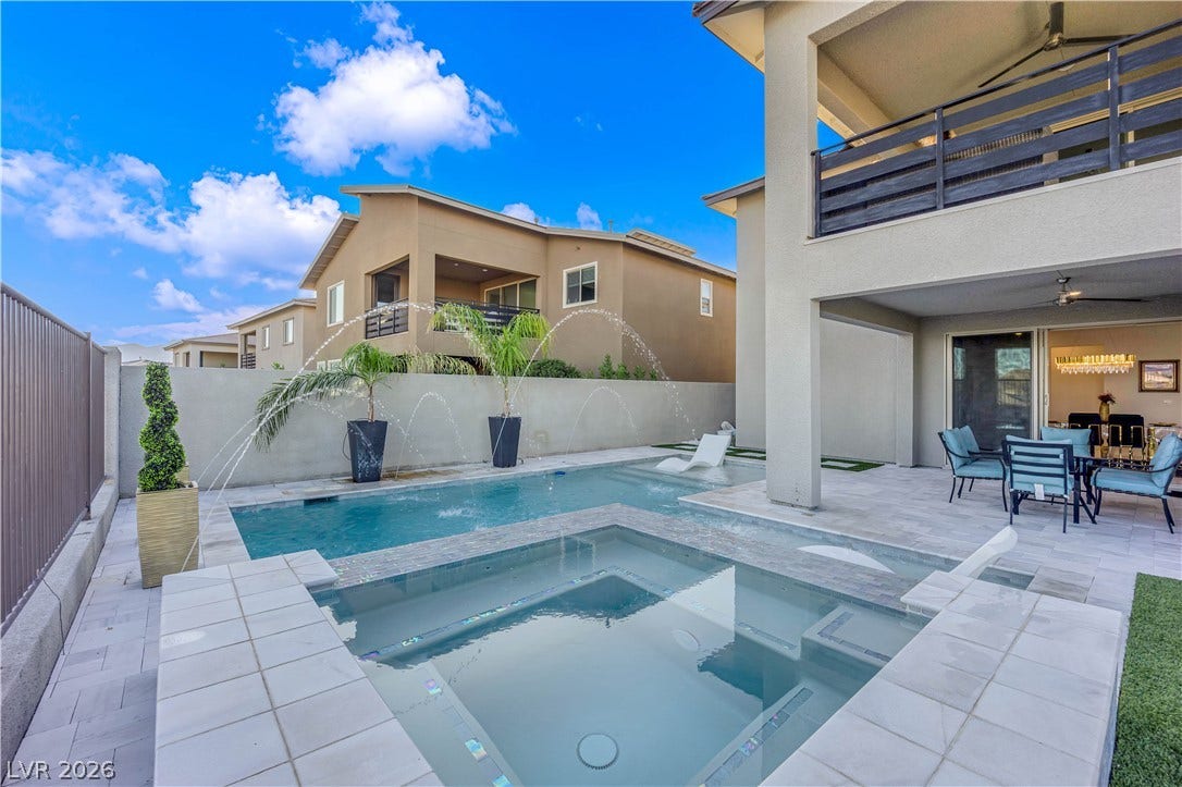 12415 Aster Hills Avenue, Las Vegas, NV 89138 backyard oasis features a clean-lined swimming pool with a matching integrated spa.