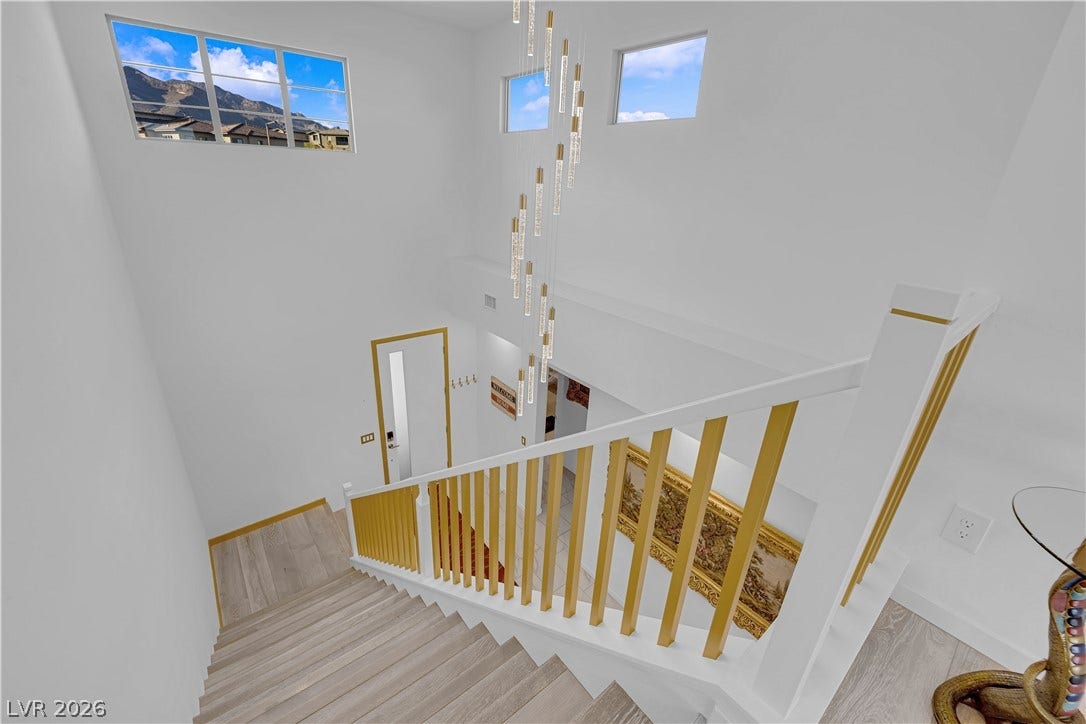 12415 Aster Hills Avenue, Las Vegas, NV 89138 High ceilings and clerestory windows frame mountain views over the modern staircase.