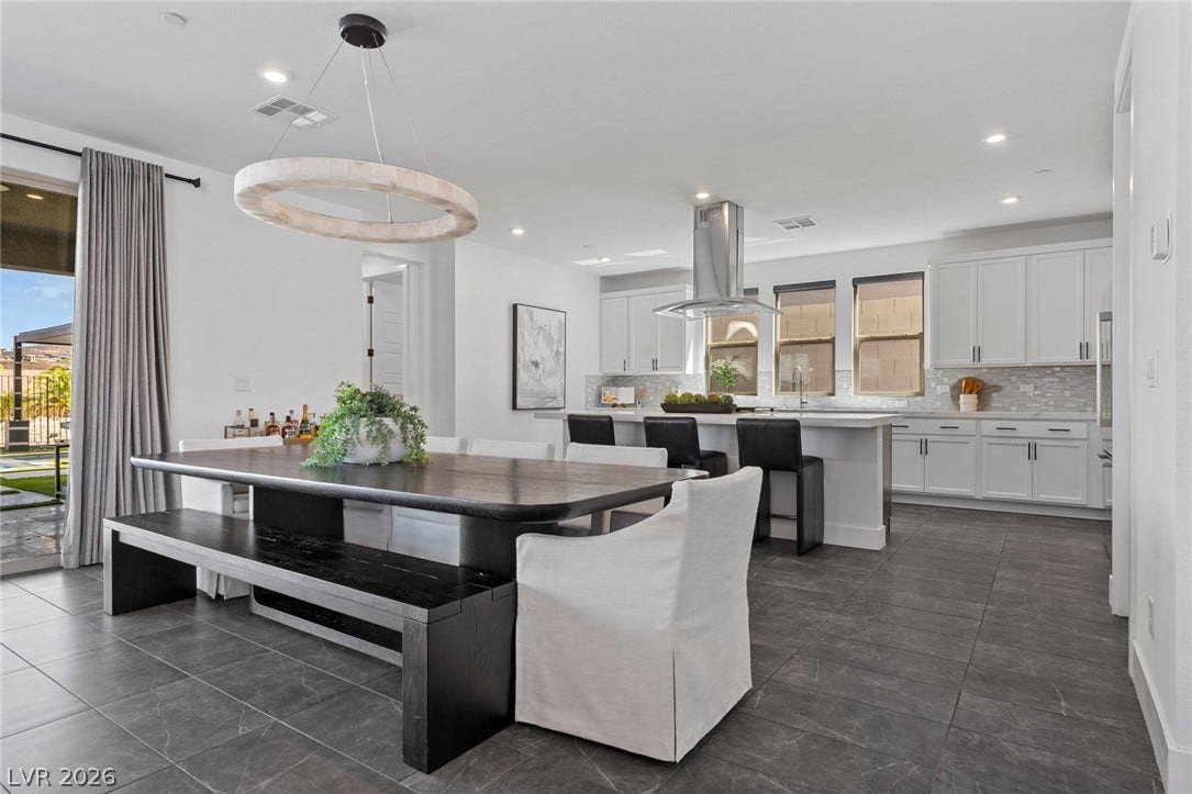 1976 Peaceful Mesa Court, Henderson, NV 89052 An open floor plan seamlessly connects the dining area to a modern kitchen with tiled flooring.