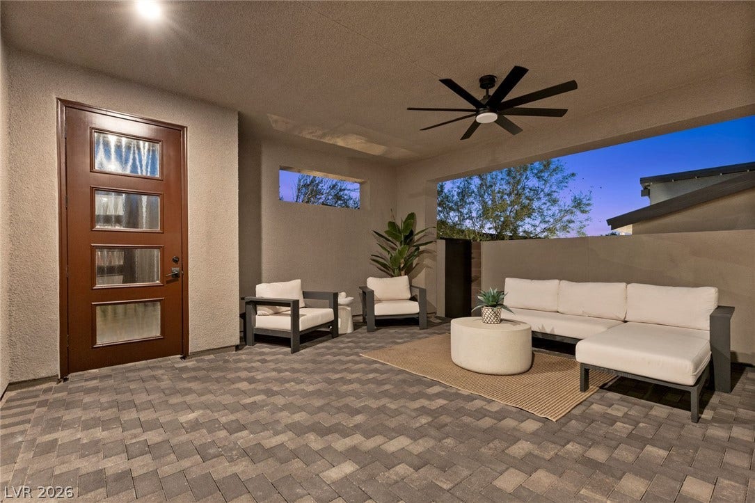 1976 Peaceful Mesa Court, Henderson, NV 89052 A spacious covered patio features herringbone-patterned stone pavers under a high stucco ceiling.