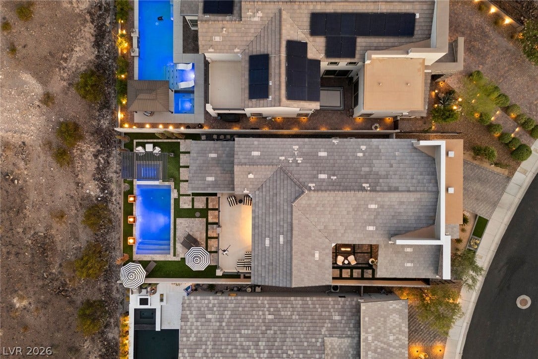 1976 Peaceful Mesa Court, Henderson, NV 89052 An aerial perspective showcases the sleek tiled roof and a glowing backyard swimming pool.