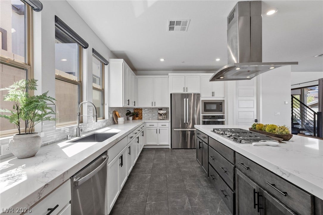 1976 Peaceful Mesa Court, Henderson, NV 89052 High ceilings, stone counters, and a central island highlight this modern culinary workspace.