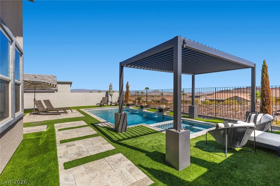 1976 Peaceful Mesa Court, Henderson, NV 89052 A stone paver path leads to a refreshing pool and integrated spa under clear skies.