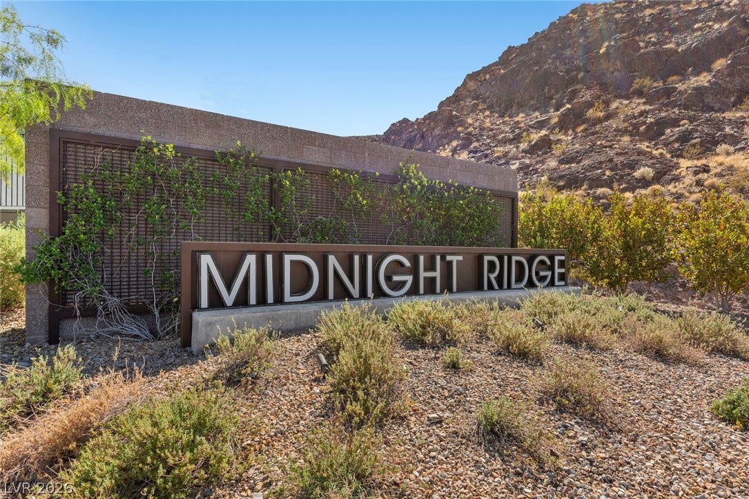 1976 Peaceful Mesa Court, Henderson, NV 89052 Rugged hills frame the textured stone monument sign welcoming residents to this hillside enclave.