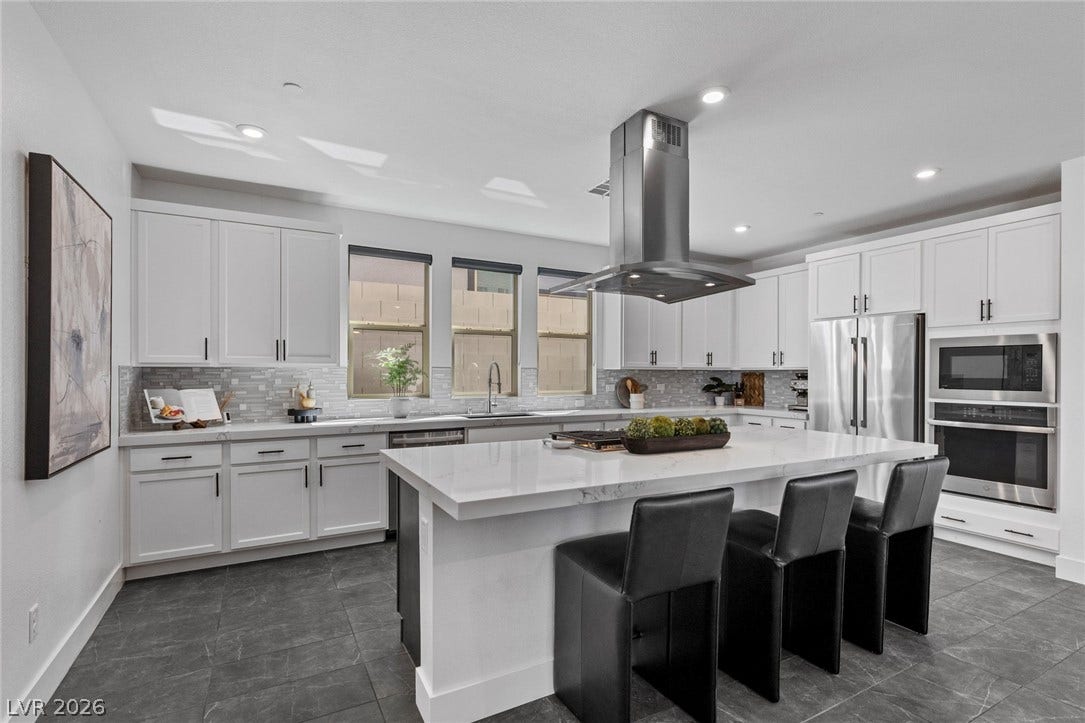 1976 Peaceful Mesa Court, Henderson, NV 89052 Gleaming stone countertops and a spacious central island anchor this contemporary kitchen workspace.