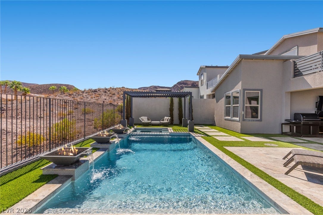 1976 Peaceful Mesa Court, Henderson, NV 89052 An inviting swimming pool and spa are paired with modern stone pavers and desert views.