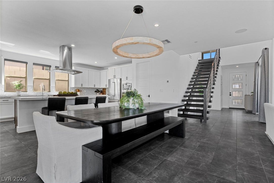 1976 Peaceful Mesa Court, Henderson, NV 89052 A floating staircase sits adjacent to an open concept kitchen and dining space.