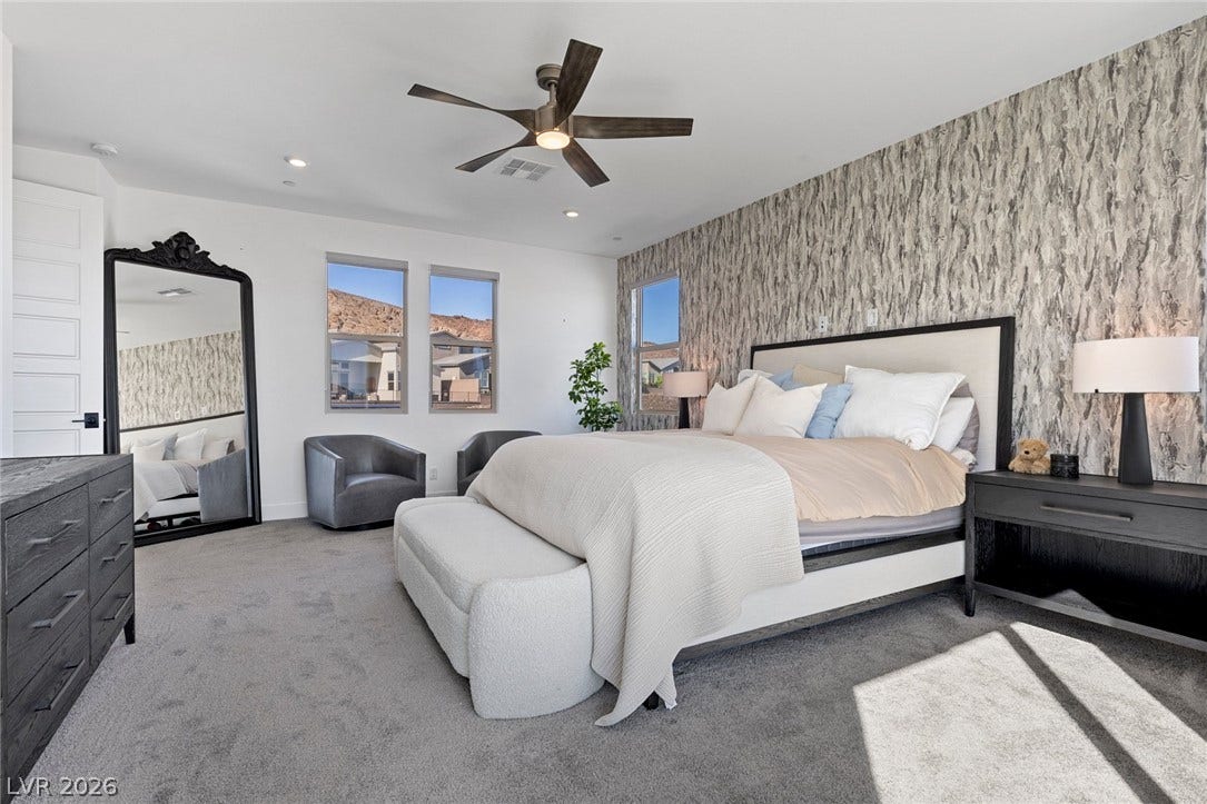 1976 Peaceful Mesa Court, Henderson, NV 89052 An textured feature wall and soft carpeting define this inviting bedroom space.