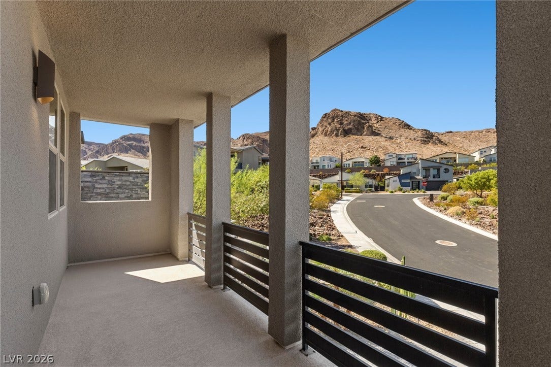 1976 Peaceful Mesa Court, Henderson, NV 89052 Dramatic mountain views framed by a covered balcony create a serene outdoor retreat.