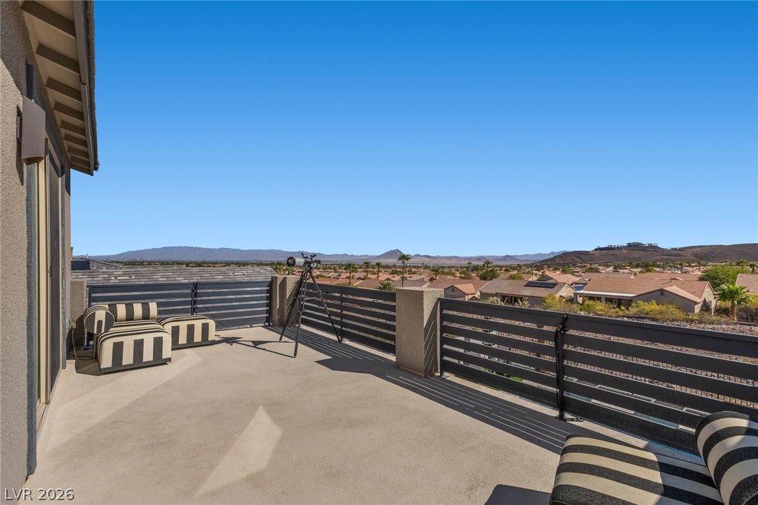 1976 Peaceful Mesa Court, Henderson, NV 89052 An elevated private balcony captures sweeping panoramic views of the valley and distant mountains.