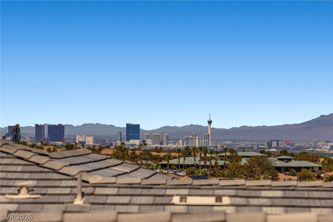 1976 Peaceful Mesa Court, Henderson, NV 89052 Clear blue skies frame far-reaching vistas of the iconic city skyline and rugged mountain ranges.