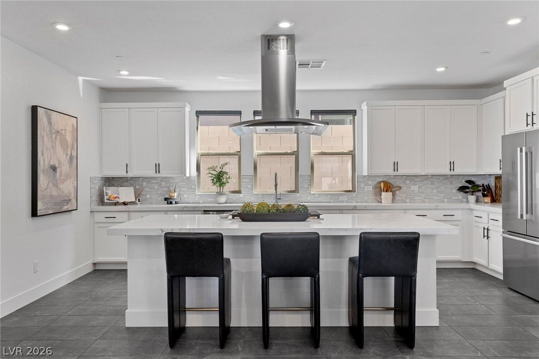 1976 Peaceful Mesa Court, Henderson, NV 89052 An expansive central island grounds this contemporary culinary space anchored by large format floor tiles.
