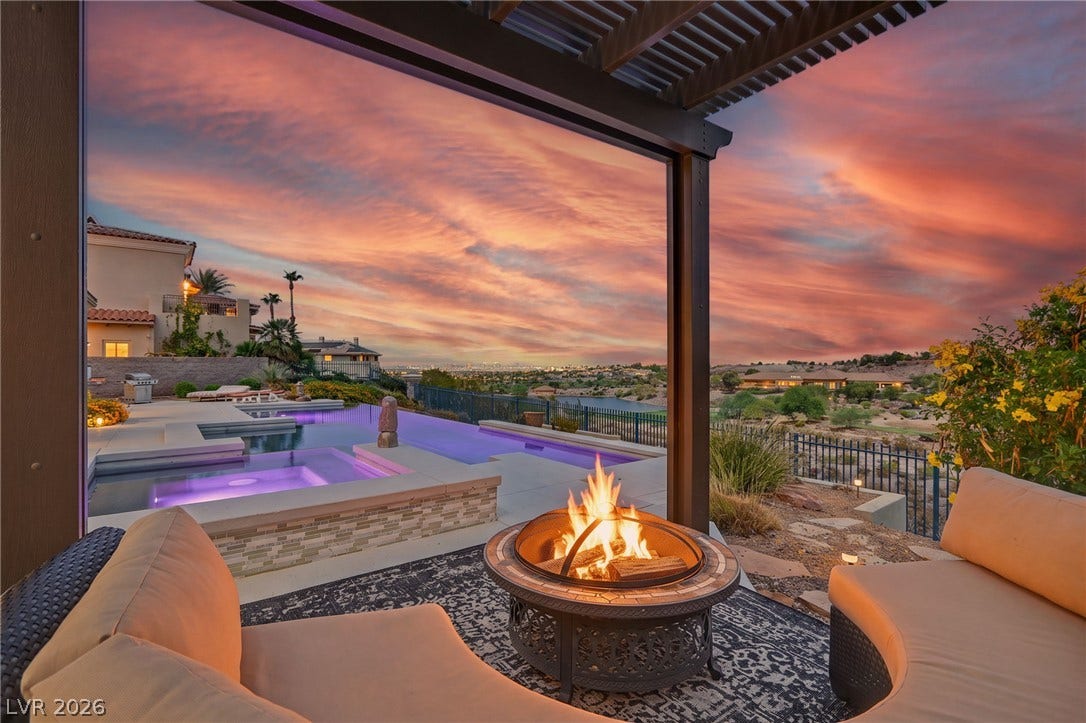1358 Opal Valley Street, Henderson, NV 89052 A covered patio with a cozy fire pit overlooks a glittering pool and scenic valley views.
