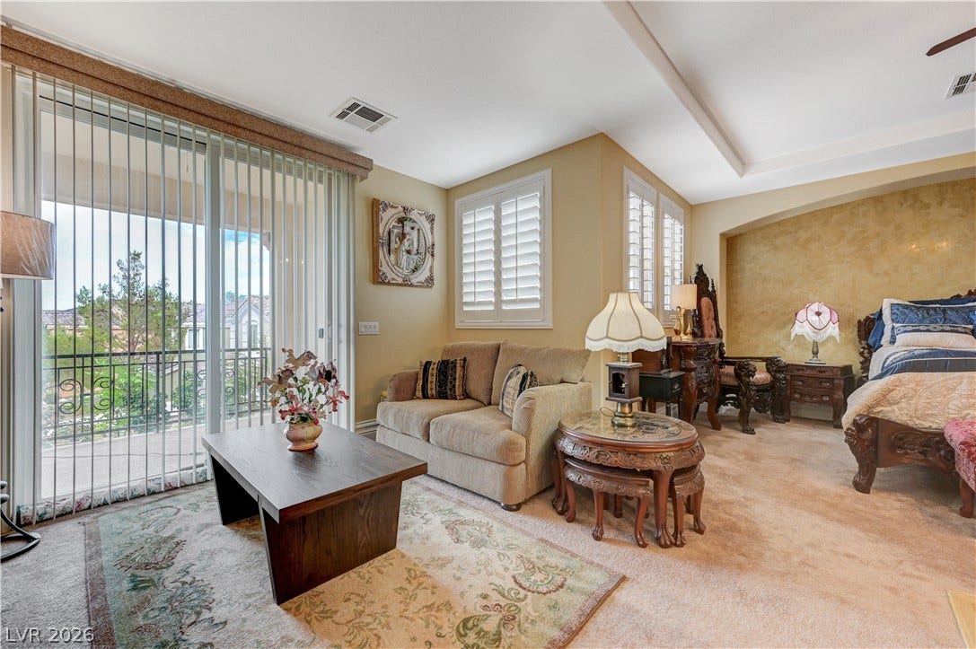 218 Crooked Putter Drive, Las Vegas, NV 89148 A spacious bedroom suite features an integrated sitting area and direct balcony access.