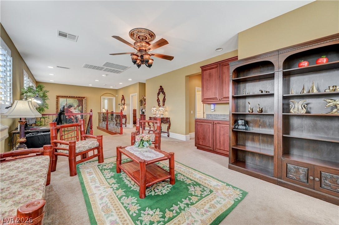 218 Crooked Putter Drive, Las Vegas, NV 89148 A spacious upper-level loft features wall-to-wall carpeting, recessed lighting, and built-in wooden cabinetry.