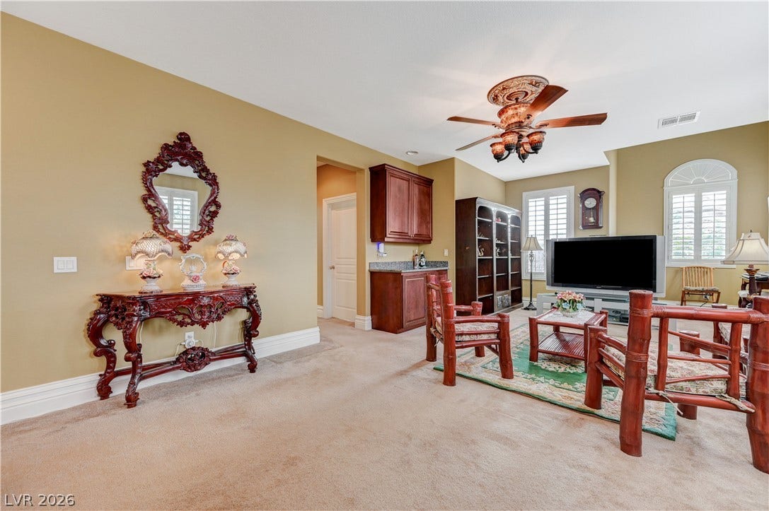 218 Crooked Putter Drive, Las Vegas, NV 89148 Plentiful natural light fills this spacious living area complete with a wet bar.