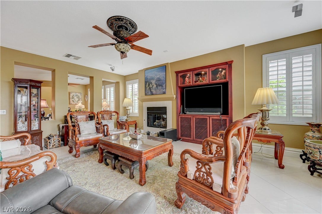 218 Crooked Putter Drive, Las Vegas, NV 89148 An inviting fireplace and built-in shelving anchor this comfortable open living area.