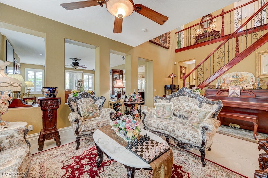 218 Crooked Putter Drive, Las Vegas, NV 89148 Dramatic high ceilings and a grand staircase frame this light-filled living area.