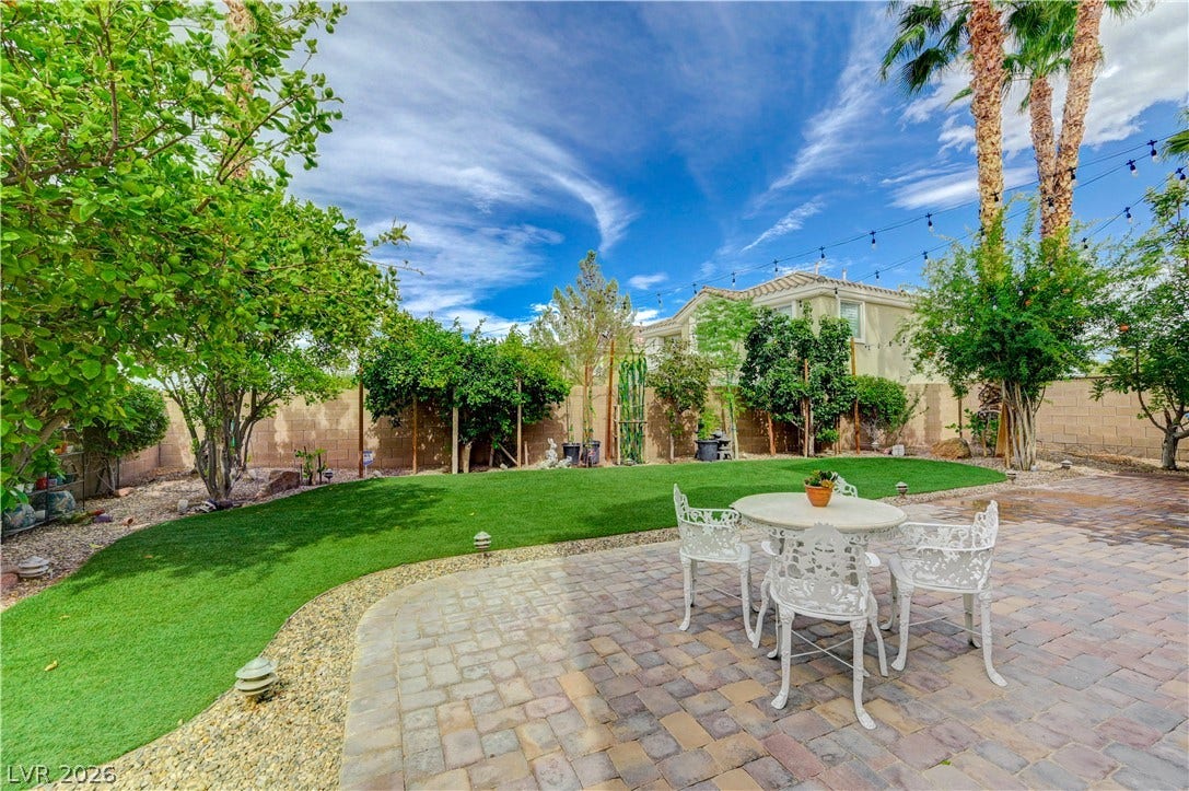 218 Crooked Putter Drive, Las Vegas, NV 89148 A spacious paved patio overlooks the lush green lawn and mature perimeter landscaping.