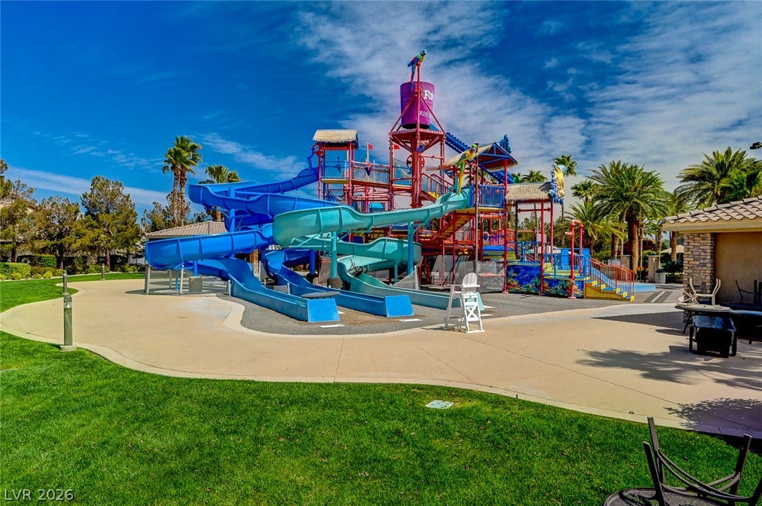 218 Crooked Putter Drive, Las Vegas, NV 89148 An expansive community water park features multiple colorful slides and a large splash structure.