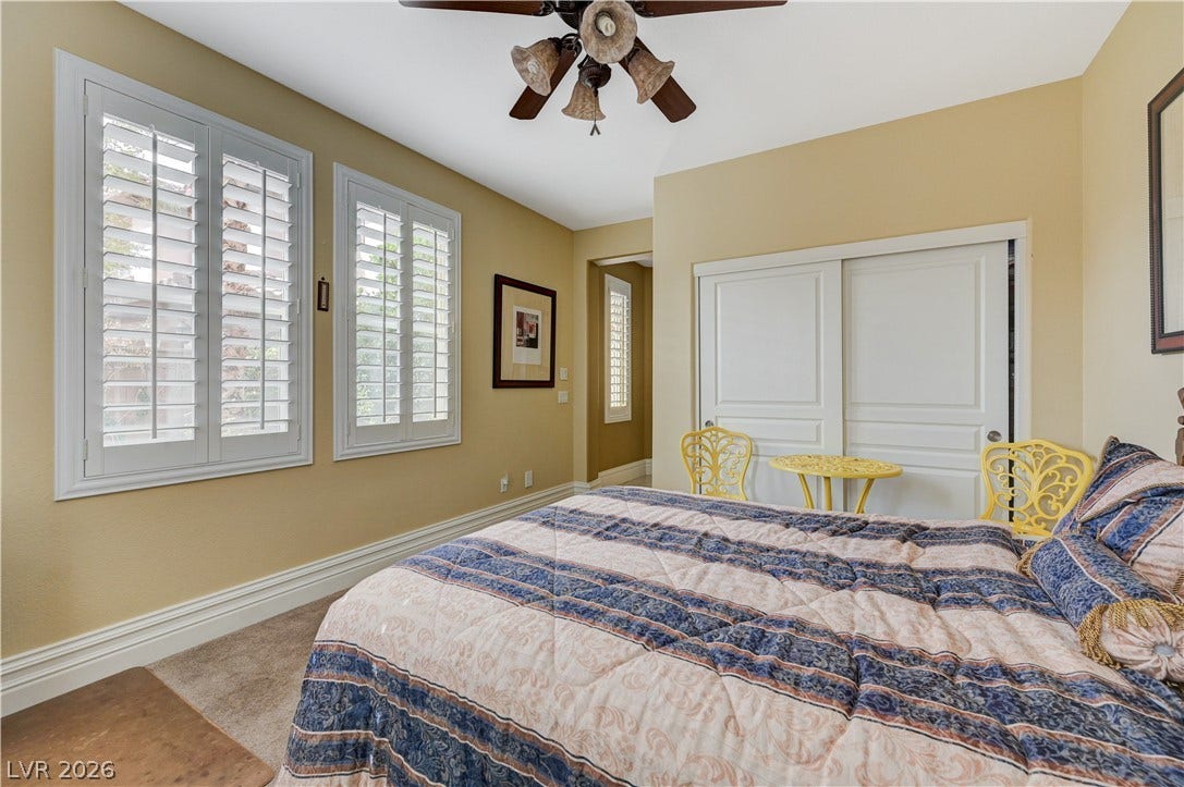 218 Crooked Putter Drive, Las Vegas, NV 89148 Plentiful natural light filters through plantation shutters into this comfortable carpeted bedroom.