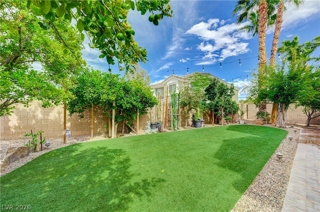 218 Crooked Putter Drive, Las Vegas, NV 89148 Lush landscaping and a neat stone perimeter fence frame this peaceful outdoor retreat.