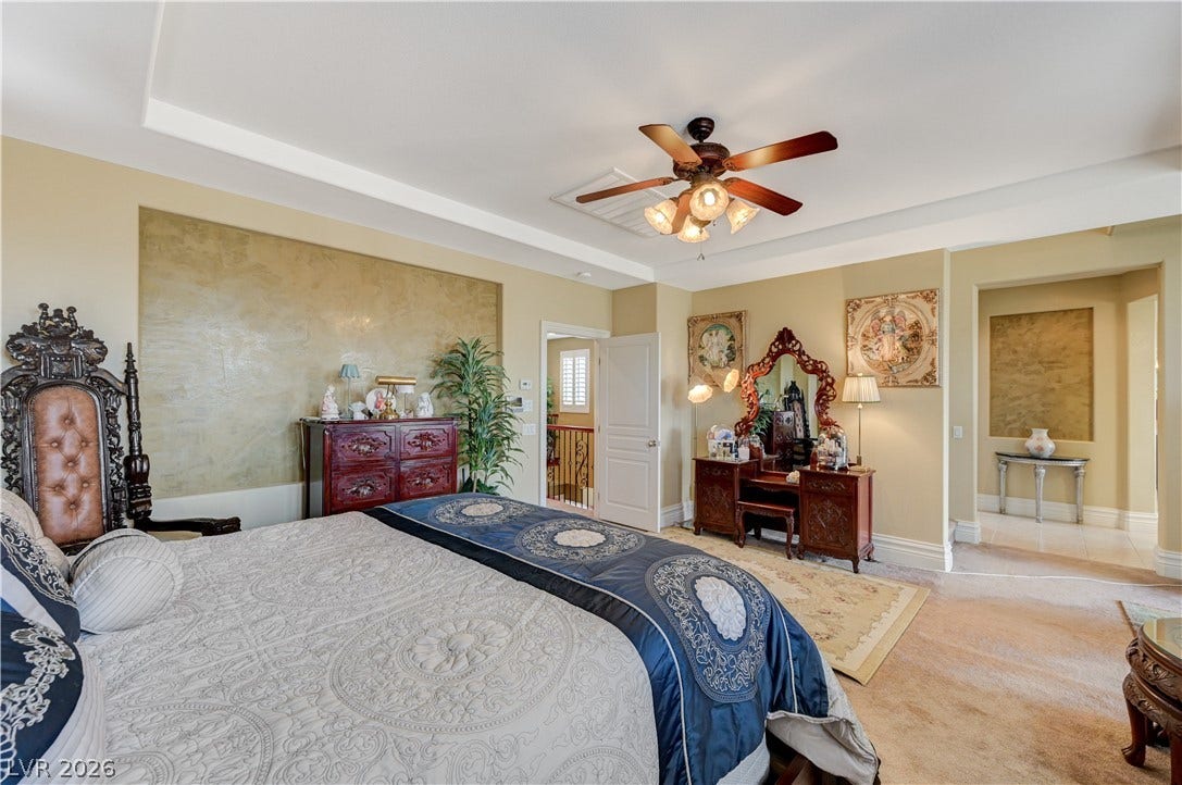 218 Crooked Putter Drive, Las Vegas, NV 89148 A tray ceiling highlights this spacious bedroom complete with plush carpeting and wide entryways.