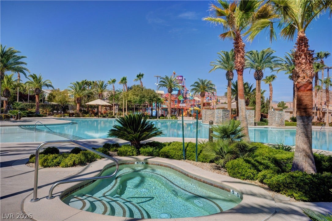 218 Crooked Putter Drive, Las Vegas, NV 89148 An inviting hot tub overlooks the community pool area framed by soaring palm trees.