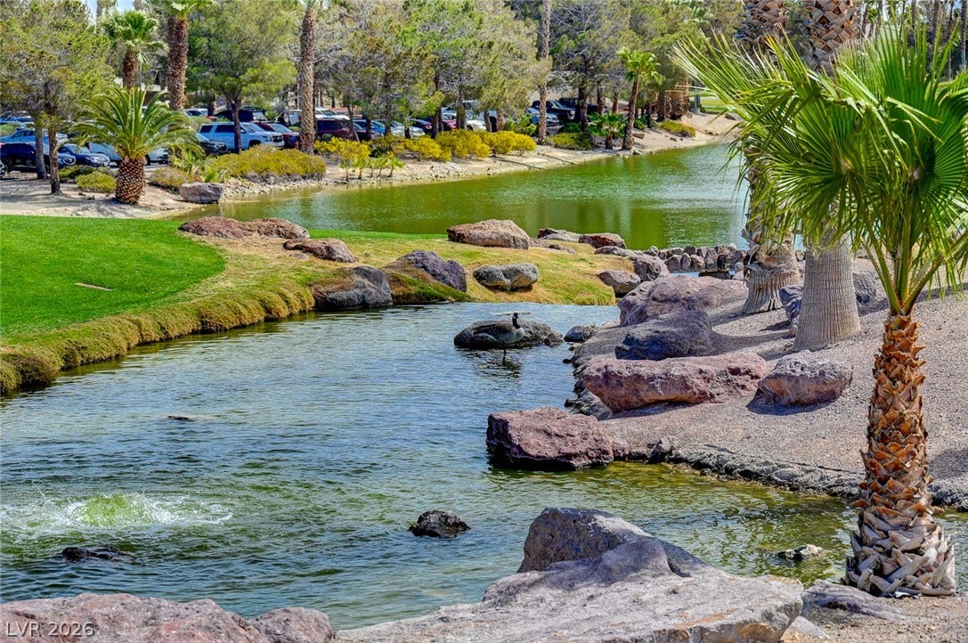 218 Crooked Putter Drive, Las Vegas, NV 89148 Lush landscaping and rocky water features create a peaceful outdoor environment.