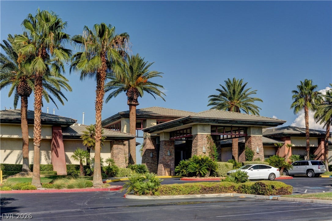 218 Crooked Putter Drive, Las Vegas, NV 89148 Palm trees frame the grand stone entryway of this impressive modern clubhouse structure.