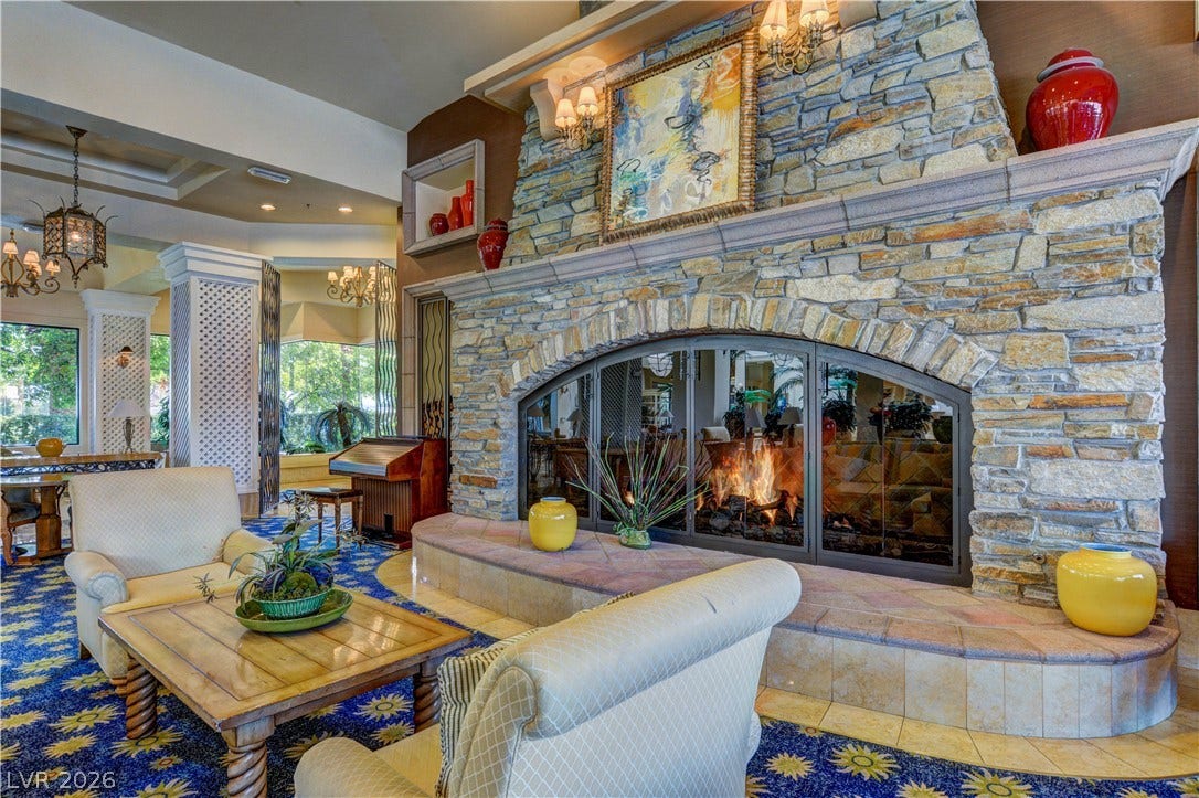 218 Crooked Putter Drive, Las Vegas, NV 89148 A massive stone fireplace with a raised hearth commands attention in this spacious gathering room.