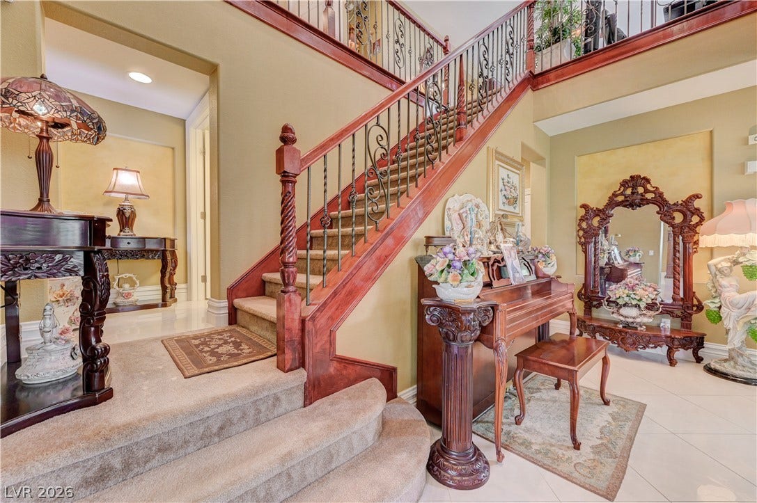 218 Crooked Putter Drive, Las Vegas, NV 89148 An elegant staircase with detailed wooden balustrades makes a grand architectural statement.