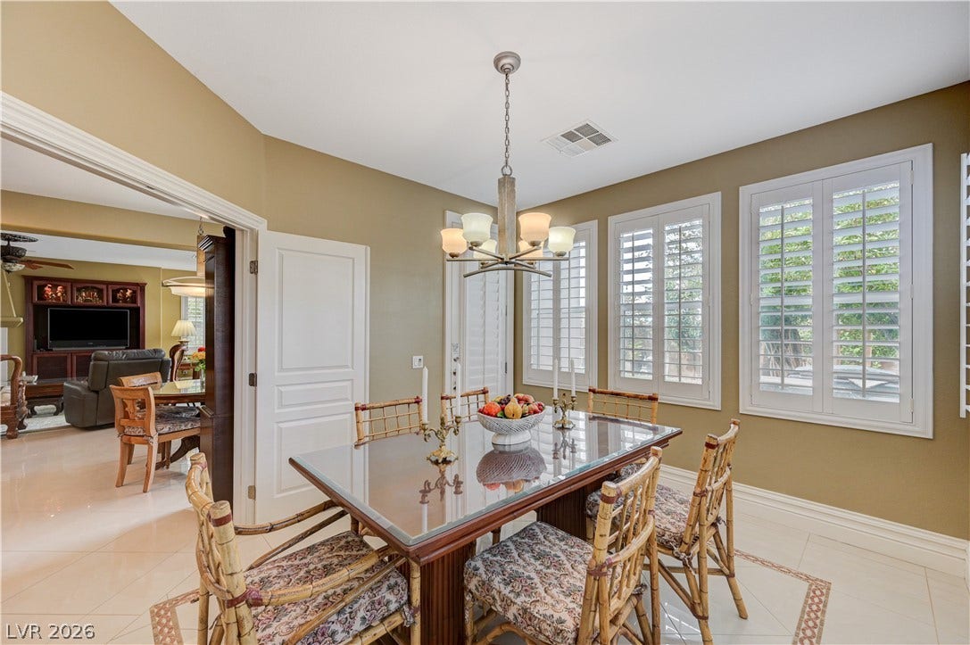 218 Crooked Putter Drive, Las Vegas, NV 89148 Polished tile flooring and plantation shutters define this inviting dining room.