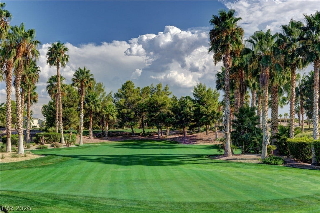 218 Crooked Putter Drive, Las Vegas, NV 89148 Lush fairways bordered by mature palm trees offer scenic golf course views under wide desert skies.