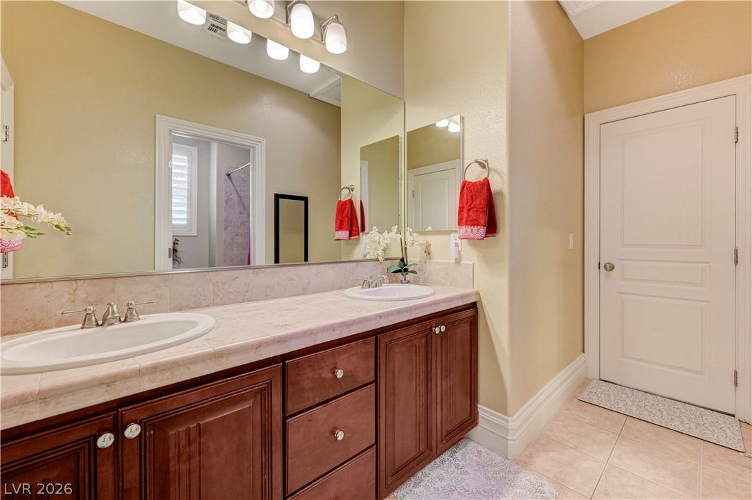 218 Crooked Putter Drive, Las Vegas, NV 89148 Ample counter space and classic cabinetry define this well-appointed bathroom.