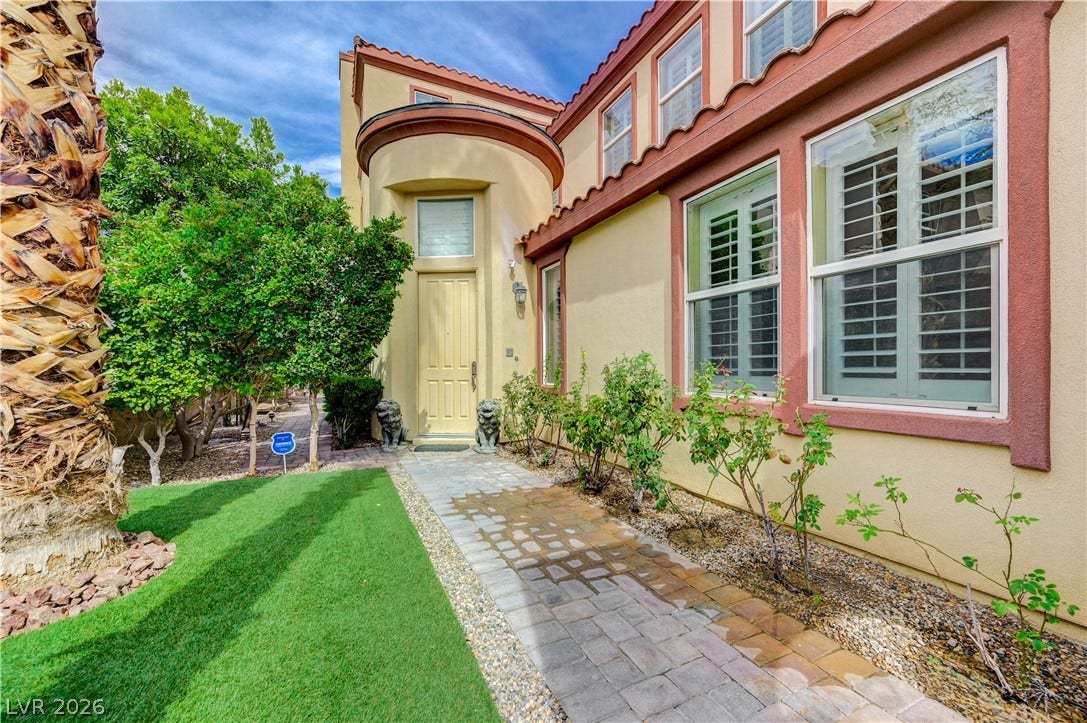 218 Crooked Putter Drive, Las Vegas, NV 89148 Mediterranean architectural details grace the entry path and stucco exterior of this multi-level residence.