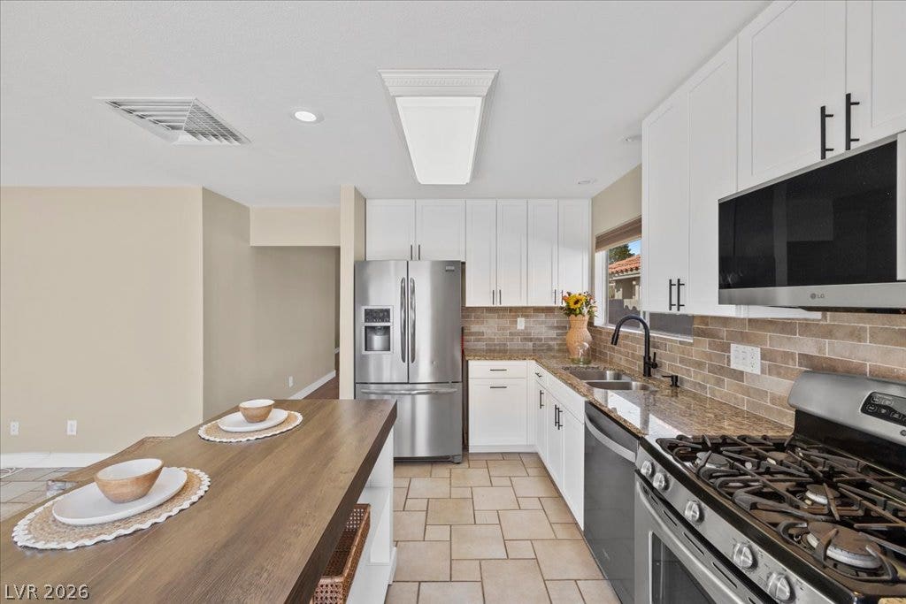2432 Millcroft Drive, Henderson, NV 89074 Tile flooring in kitchen and den.
