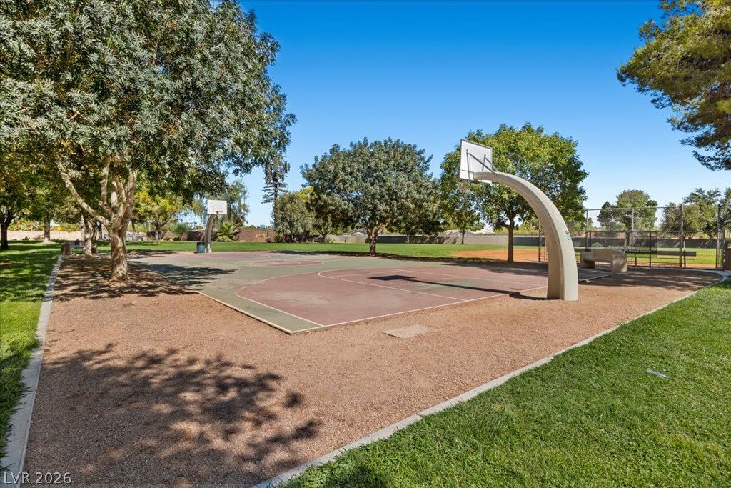 2432 Millcroft Drive, Henderson, NV 89074 Lush mature trees shade a spacious outdoor basketball court set alongside a grassy park.