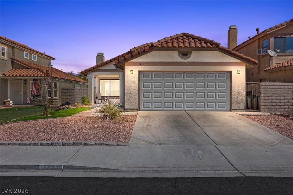 2432 Millcroft Drive, Henderson, NV 89074 A classic tile roof and neat stucco exterior define this inviting suburban residence.