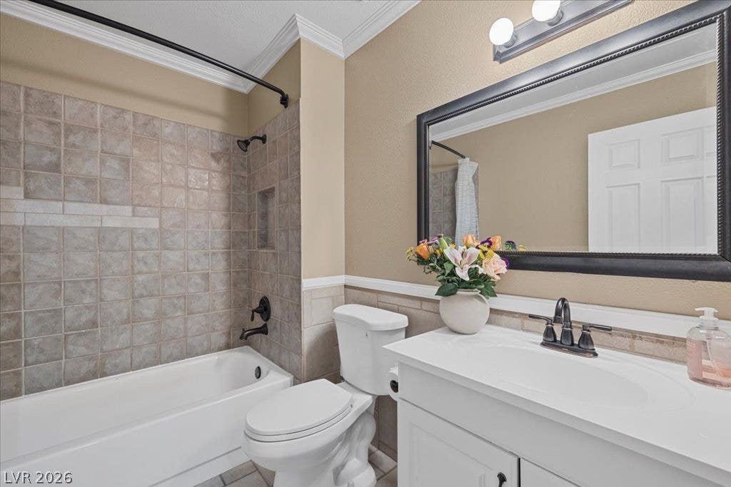 2432 Millcroft Drive, Henderson, NV 89074 Crown molding and textured wall tiles elevate this functional bathroom space.
