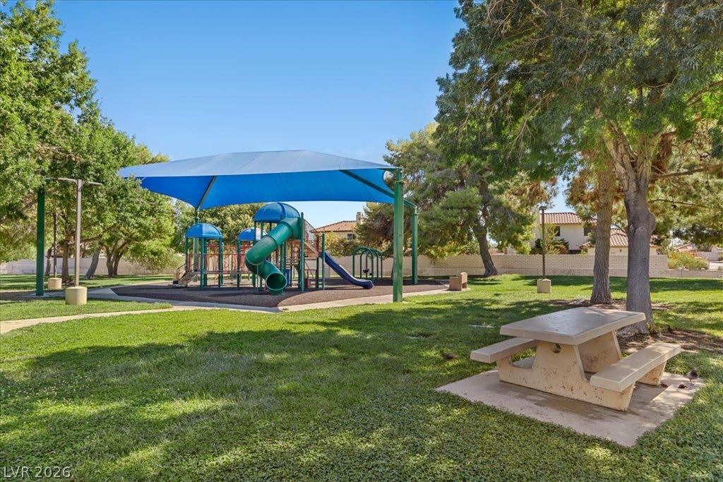 2432 Millcroft Drive, Henderson, NV 89074 Mature trees shade a neighborhood park featuring a modern playground structure and picnic area.