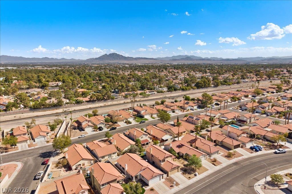 2432 Millcroft Drive, Henderson, NV 89074 Sweeping neighborhood views stretch toward distant mountain peaks under a clear blue sky.
