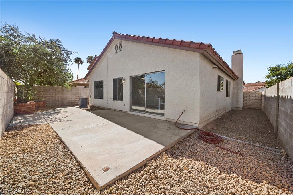 2432 Millcroft Drive, Henderson, NV 89074 A spacious concrete patio highlights the walled backyard of this tile-roofed stucco home.
