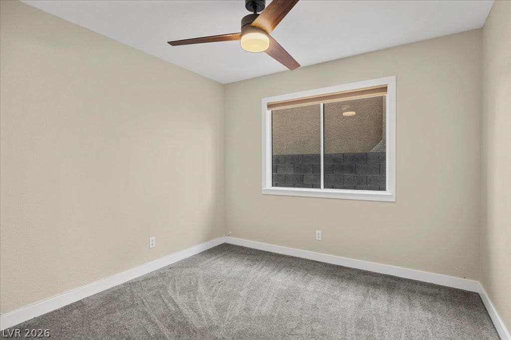 2432 Millcroft Drive, Henderson, NV 89074 Soft carpeting pairs with neutral walls and a bright window in this versatile space.