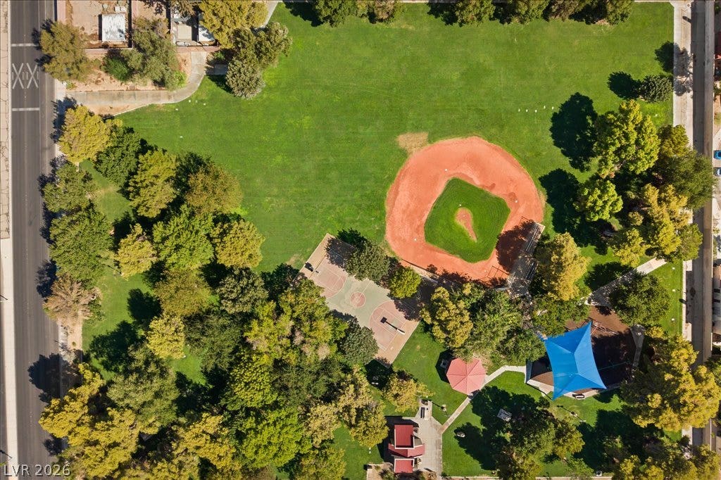 2432 Millcroft Drive, Henderson, NV 89074 Lush neighborhood park features a baseball diamond, basketball court, and shaded playground areas.
