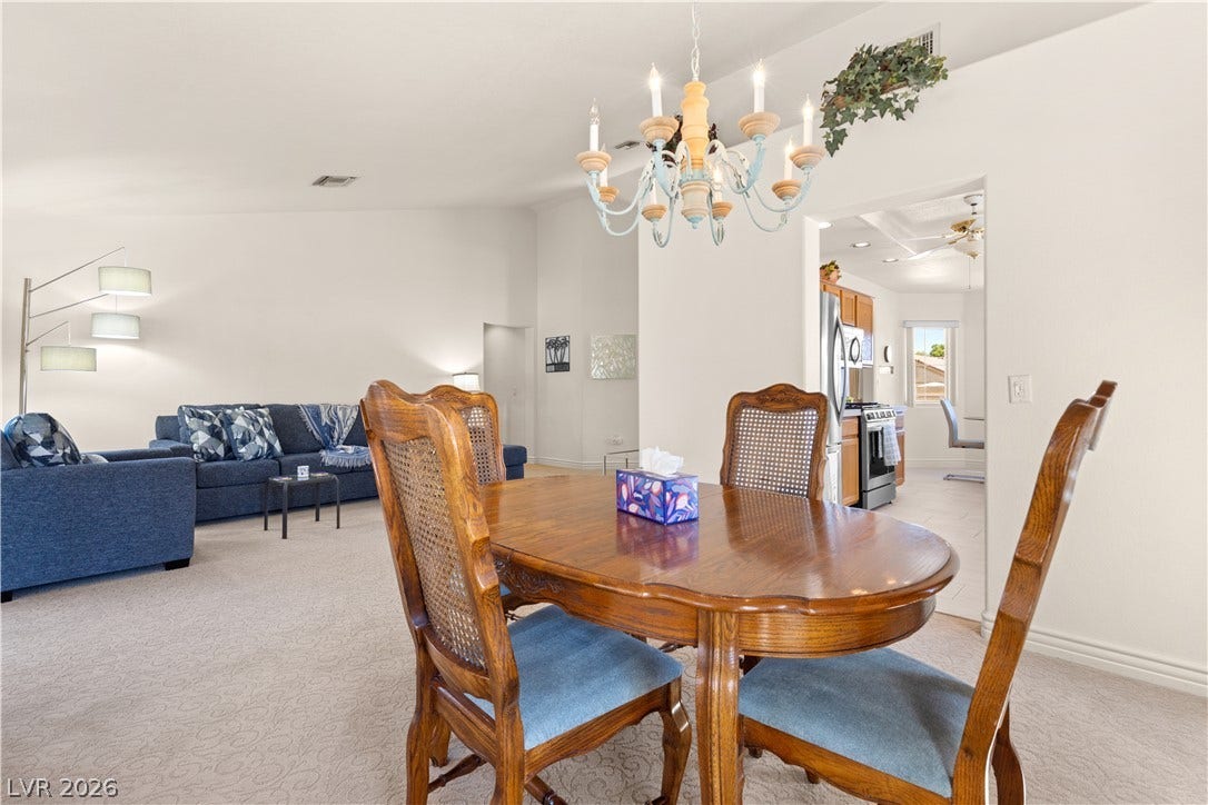 An open layout connects the carpeted dining area to the adjacent living space.