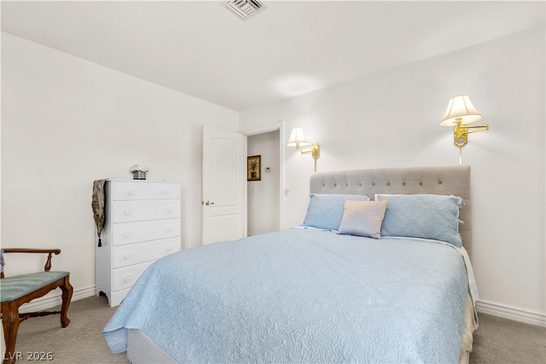 Soft carpeting pairs with classic details in this serene sleeping space.