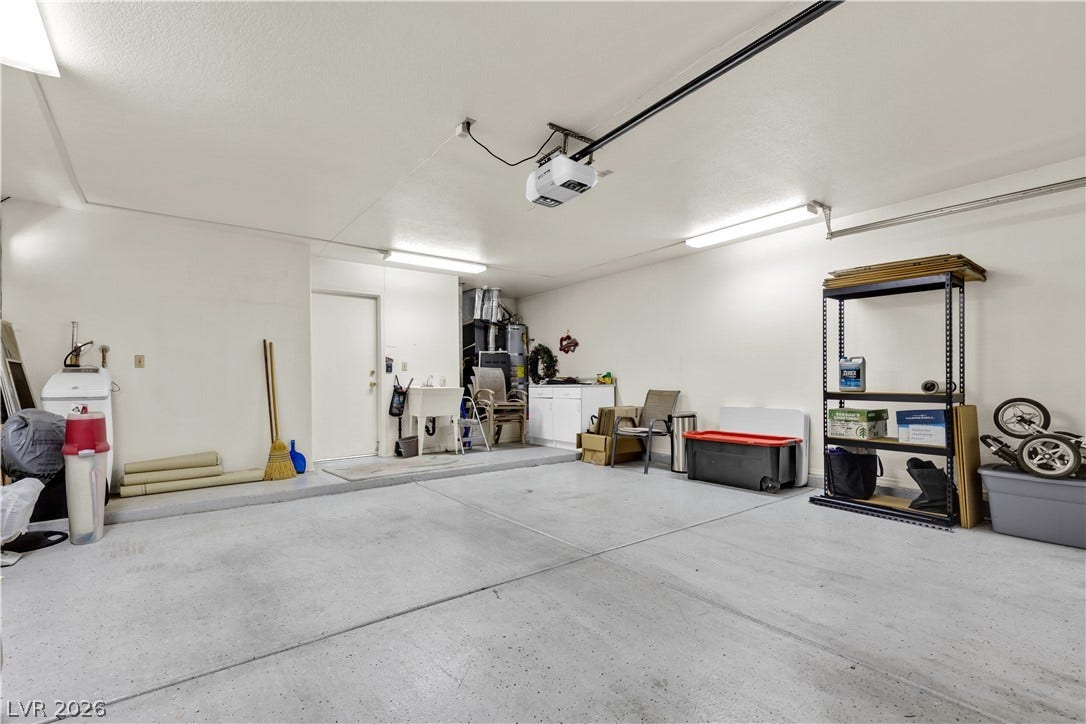 A spacious garage includes durable concrete flooring and direct interior entry.